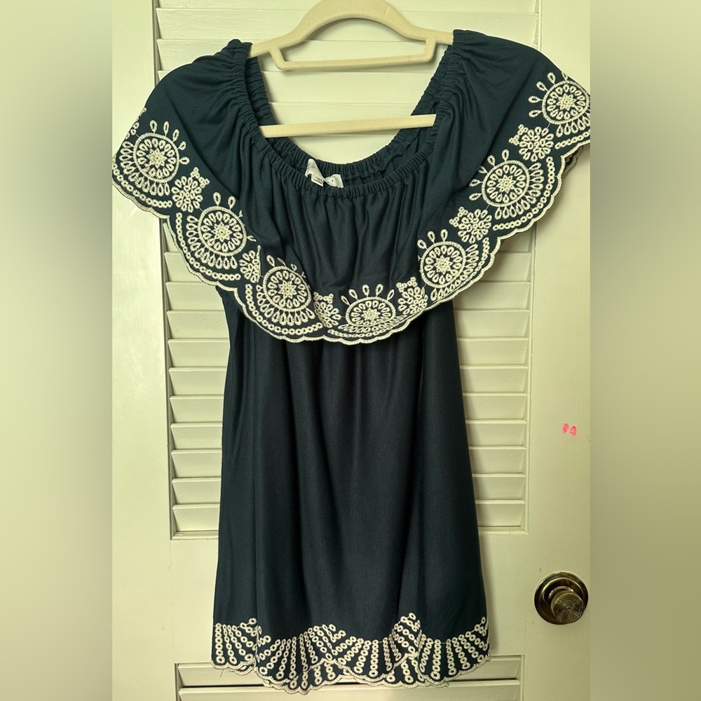 Blue shirt with scalloped bottom. Never worn. Can be worn off shoulders.
